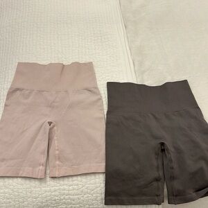 Two pairs of TNA biker shorts